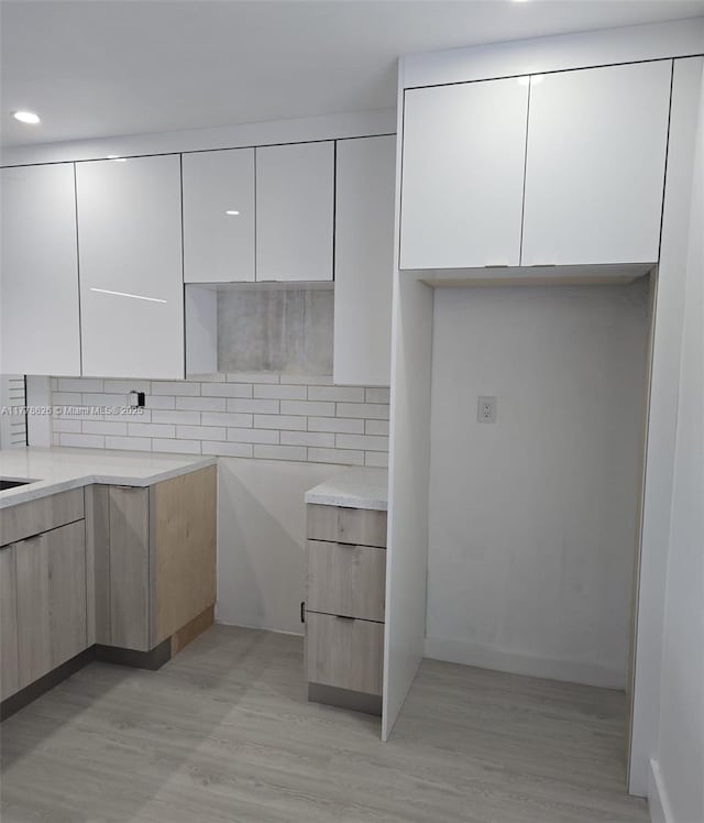 3242 NW 87th Ter, Miami, FL 33147 - kitchen featuring light wood-style floors, modern cabinets, and white cabinets