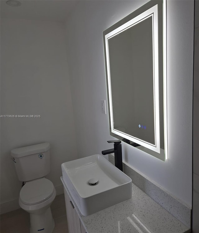 3242 NW 87th Ter, Miami, FL 33147 - bathroom featuring toilet, vanity, and baseboards