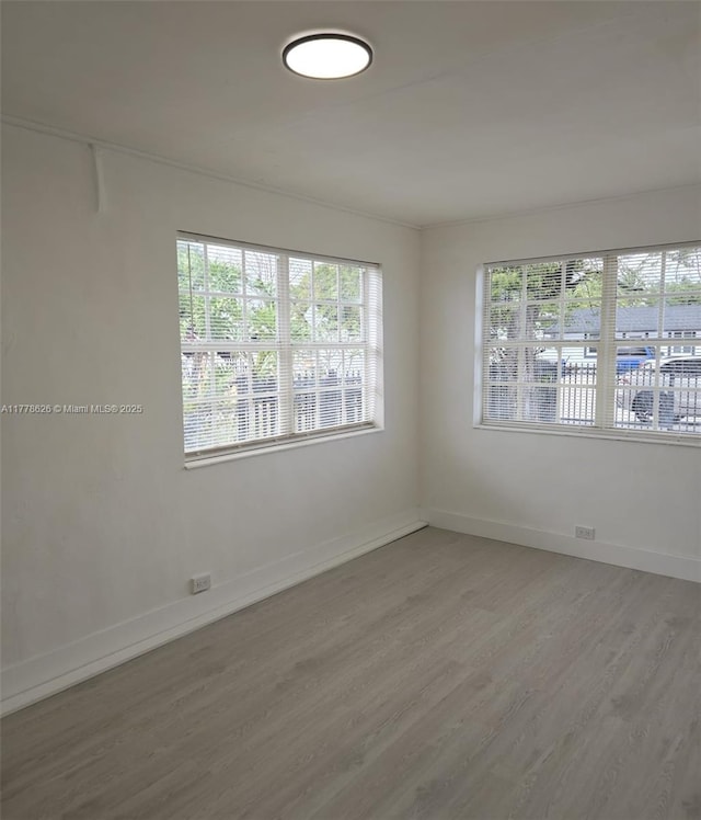 3242 NW 87th Ter, Miami, FL 33147 - unfurnished room with baseboards and wood finished floors