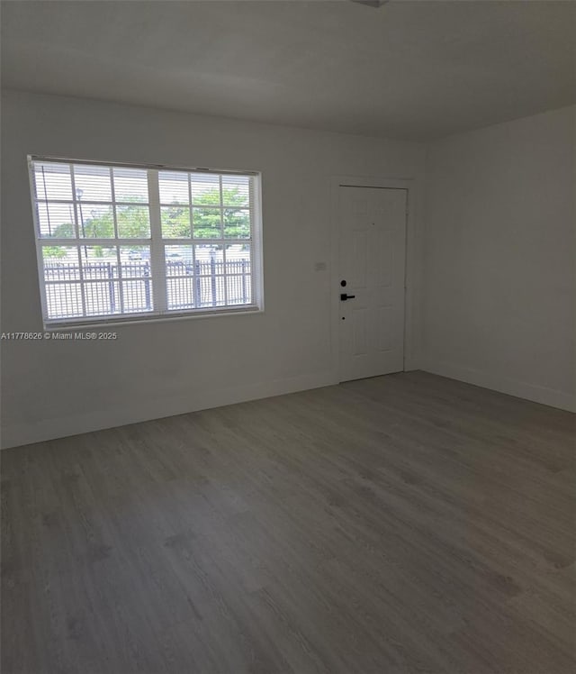 3242 NW 87th Ter, Miami, FL 33147 - unfurnished room featuring baseboards and wood finished floors