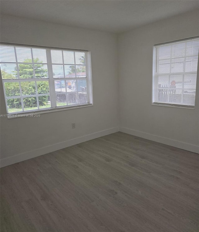 3242 NW 87th Ter, Miami, FL 33147 - empty room with wood finished floors and baseboards