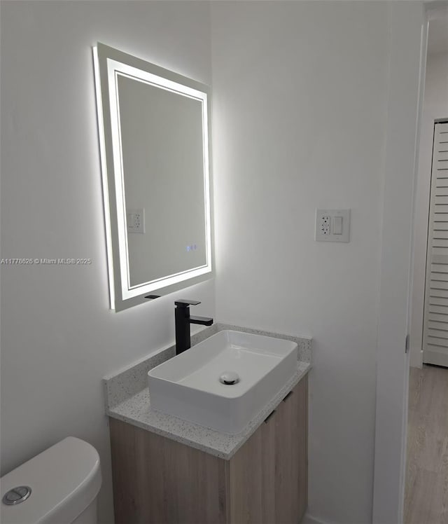 3242 NW 87th Ter, Miami, FL 33147 - bathroom with vanity, toilet, and wood finished floors