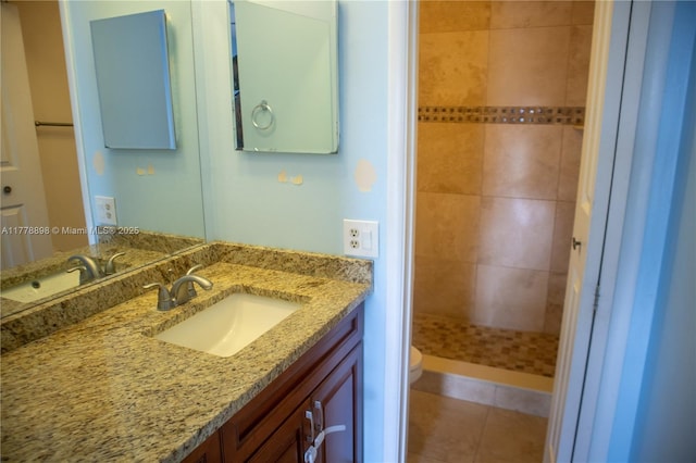 bathroom with a shower stall, tile patterned floors, vanity, and toilet