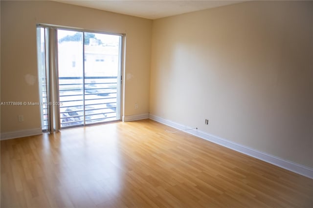 unfurnished room featuring light wood-style flooring and baseboards