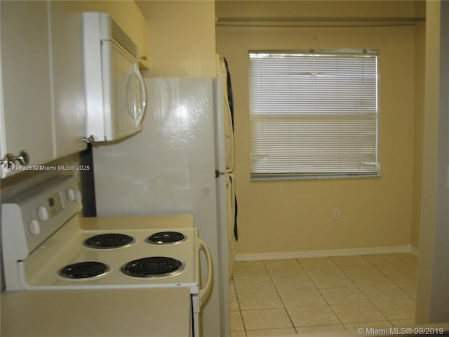 2322 SE 23rd Ave Unit 2322, Homestead, FL 33035 - kitchen with light tile patterned flooring, baseboards, and white appliances