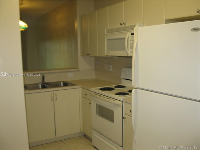 2322 SE 23rd Ave Unit 2322, Homestead, FL 33035 - kitchen featuring white appliances, light countertops, a sink, and light tile patterned floors