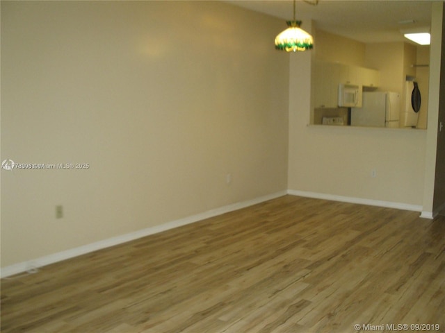 2322 SE 23rd Ave Unit 2322, Homestead, FL 33035 - empty room featuring light wood-style flooring and baseboards