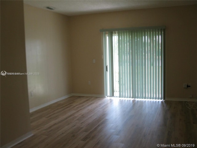 2322 SE 23rd Ave Unit 2322, Homestead, FL 33035 - unfurnished room with wood finished floors, baseboards, and plenty of natural light