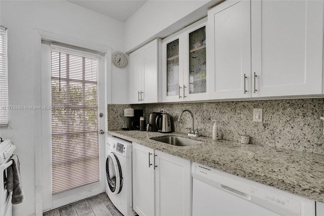 laundry room featuring washer / dryer, light wood finished floors, a sink, and laundry area
