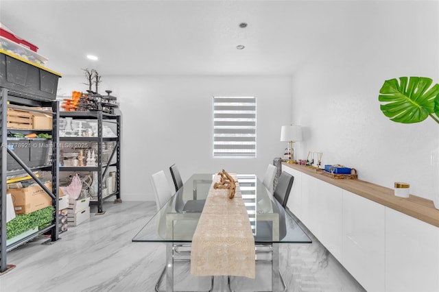 dining space featuring recessed lighting and marble finish floor