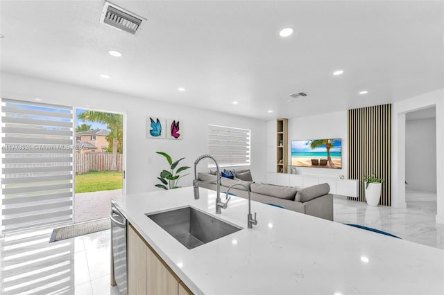 kitchen featuring dishwasher, a sink, visible vents, and recessed lighting