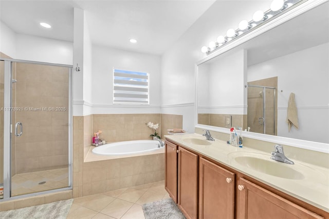 bathroom with tile patterned floors, a garden tub, a sink, and a stall shower