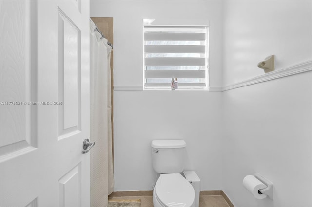 full bath featuring toilet and tile patterned flooring
