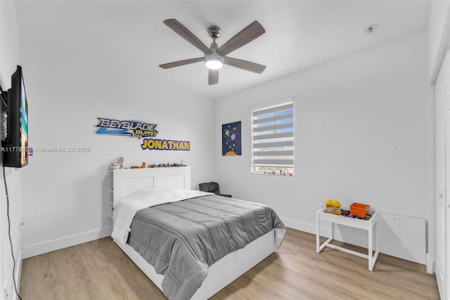 bedroom featuring light wood-style flooring, ceiling fan, and baseboards