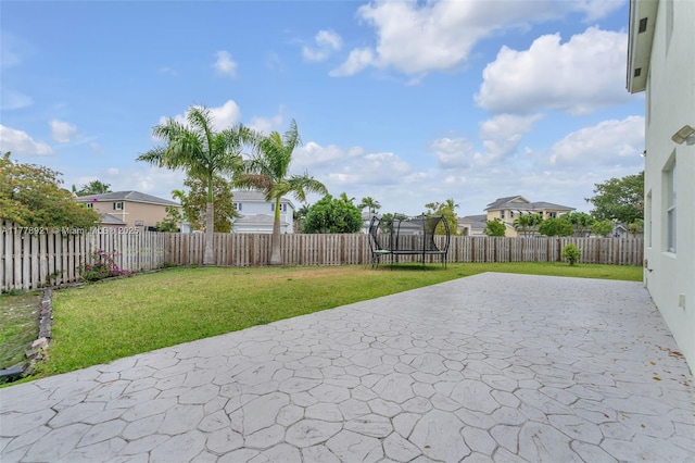 view of patio / terrace with a trampoline and a fenced backyard