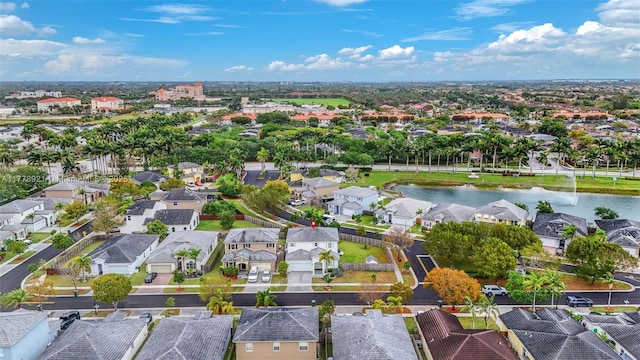 drone / aerial view with a residential view and a water view