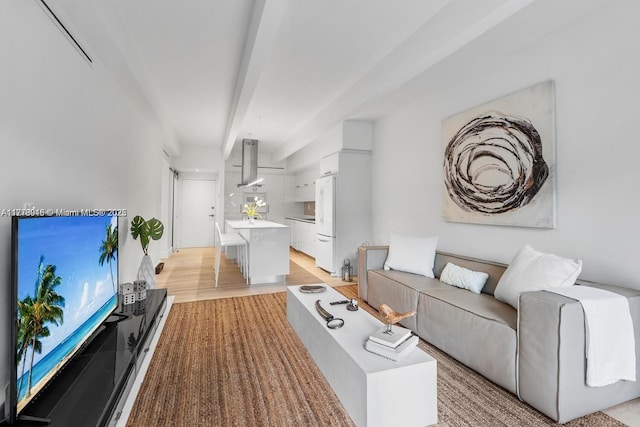 living room with light wood-style flooring and beam ceiling