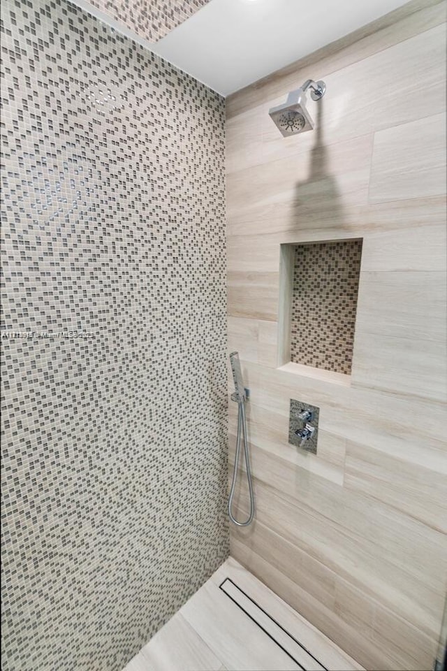 full bathroom with a tile shower