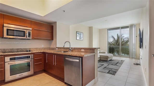 2681 N Flamingo Rd Unit 306S, Sunrise, FL 33323 - kitchen featuring stainless steel appliances, light tile patterned floors, a peninsula, and modern cabinets
