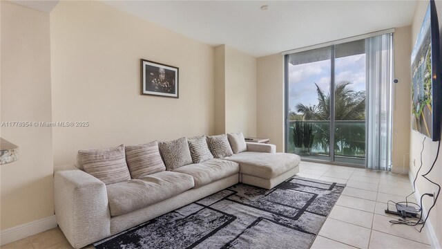 2681 N Flamingo Rd Unit 306S, Sunrise, FL 33323 - tiled living room with expansive windows and baseboards