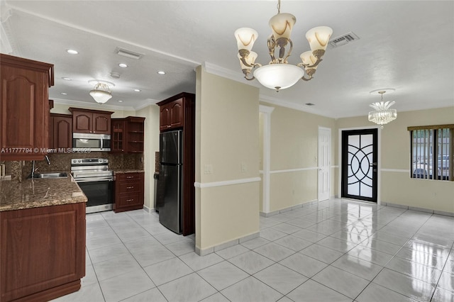 kitchen featuring tasteful backsplash, visible vents, a chandelier, and stainless steel appliances