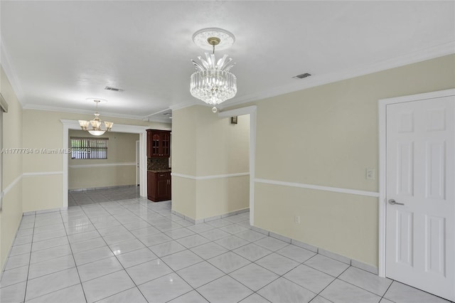 empty room with ornamental molding, visible vents, an inviting chandelier, and light tile patterned floors