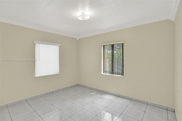 unfurnished room with light tile patterned floors, baseboards, and crown molding