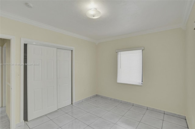 unfurnished bedroom with a closet, light tile patterned flooring, and ornamental molding