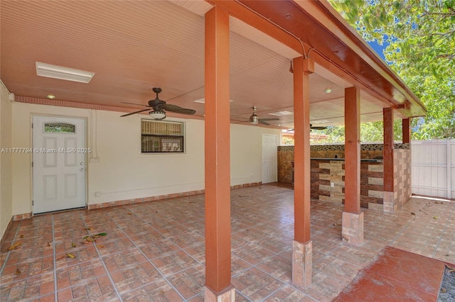 view of patio / terrace with ceiling fan and fence