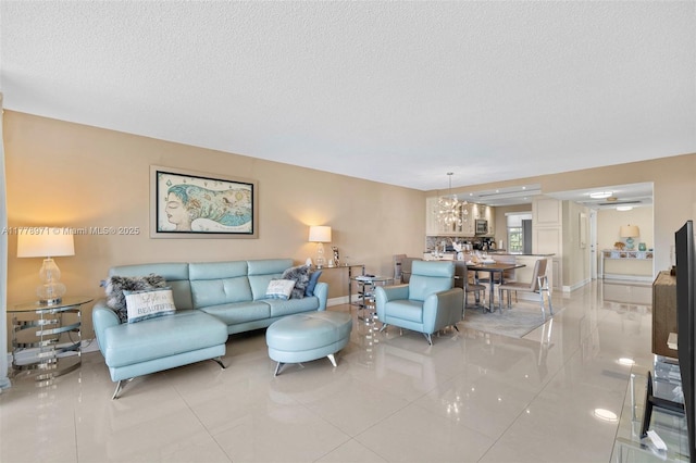 living room with baseboards, a textured ceiling, and light tile patterned floors