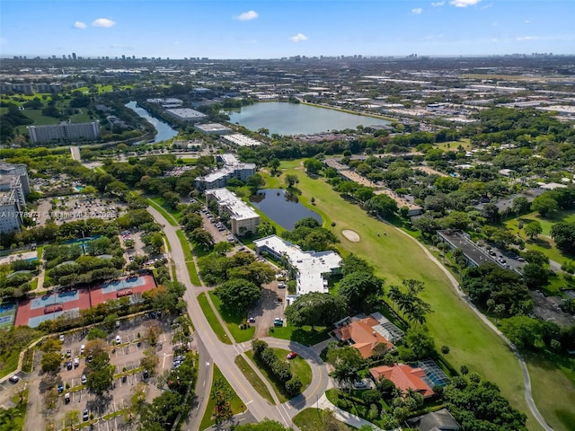 drone / aerial view with golf course view and a water view