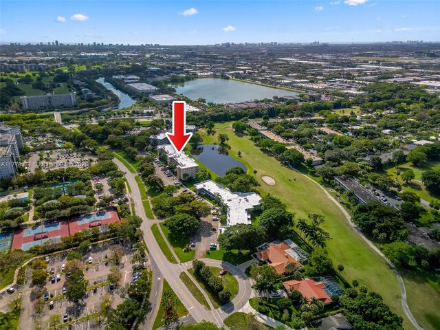bird's eye view featuring golf course view and a water view