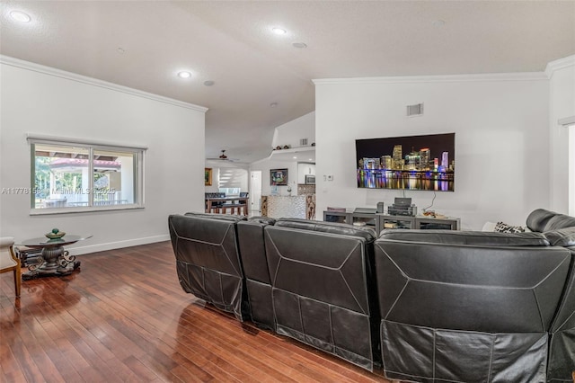 living room with vaulted ceiling, visible vents, baseboards, crown molding, and wood-type flooring
