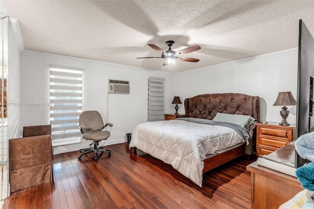 bedroom with crown molding, a textured ceiling, dark wood-type flooring, and a wall mounted air conditioner