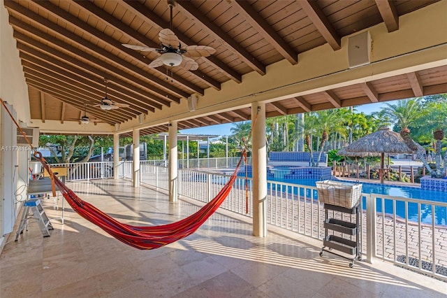 view of patio / terrace featuring ceiling fan, a fenced in pool, and fence