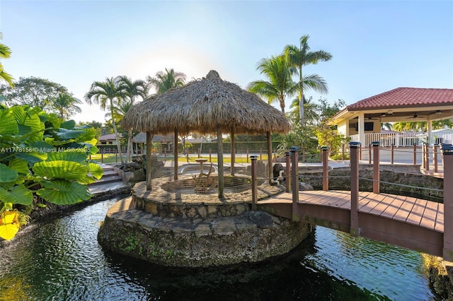 view of dock featuring a gazebo and a water view