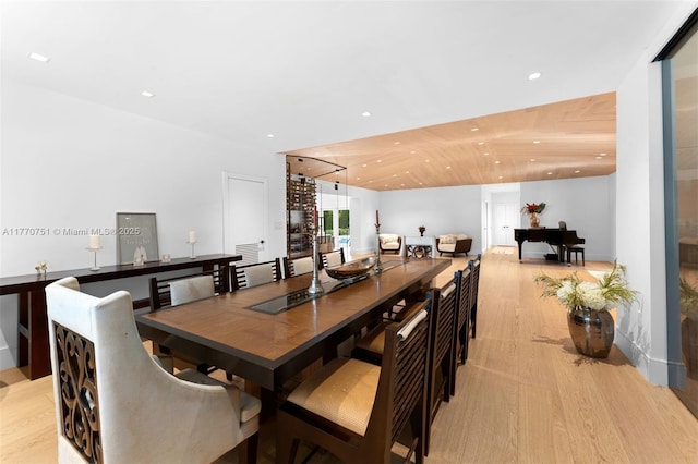 dining room with light wood-type flooring and recessed lighting