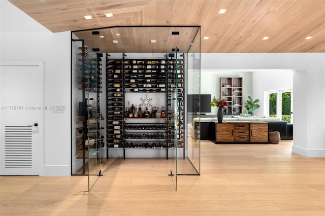 wine area with wooden ceiling and wood finished floors