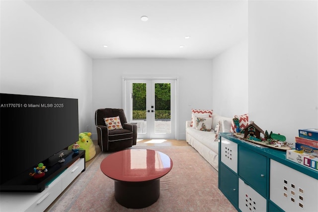 recreation room with french doors and light carpet