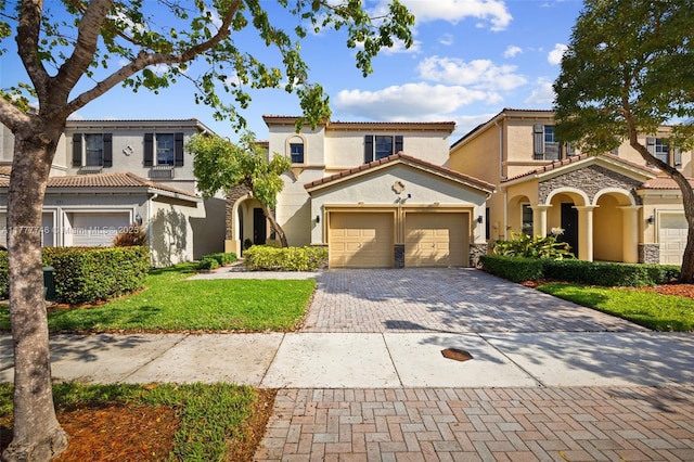 view of front facade with an attached garage, a tiled roof, stucco siding, and decorative driveway