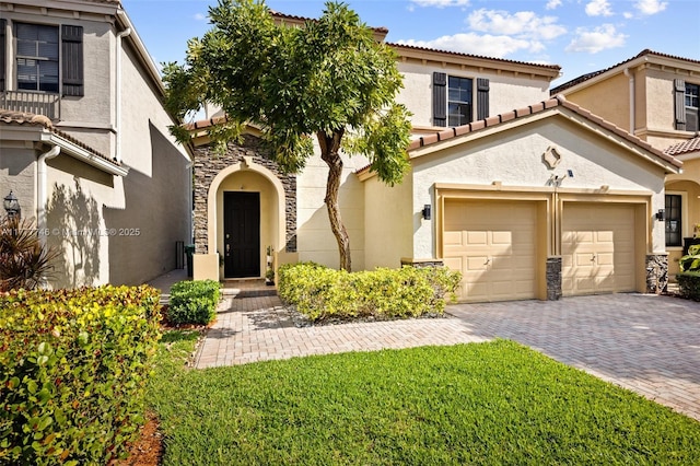 mediterranean / spanish-style house featuring a tile roof, a garage, decorative driveway, and stucco siding