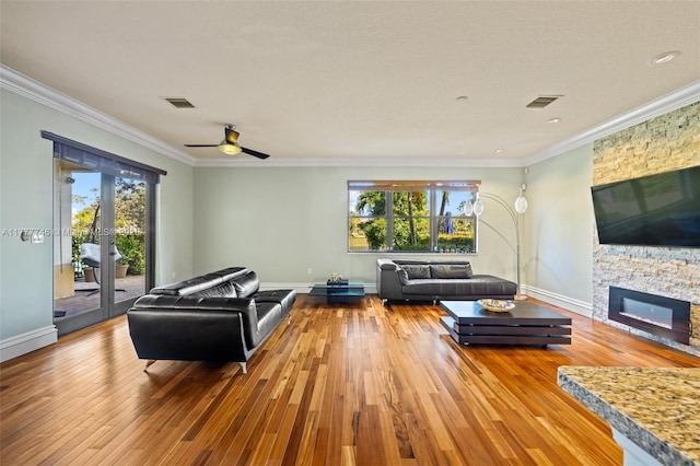 living room featuring crown molding, visible vents, and wood-type flooring