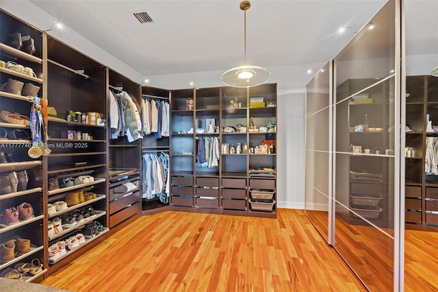 walk in closet featuring visible vents and wood finished floors