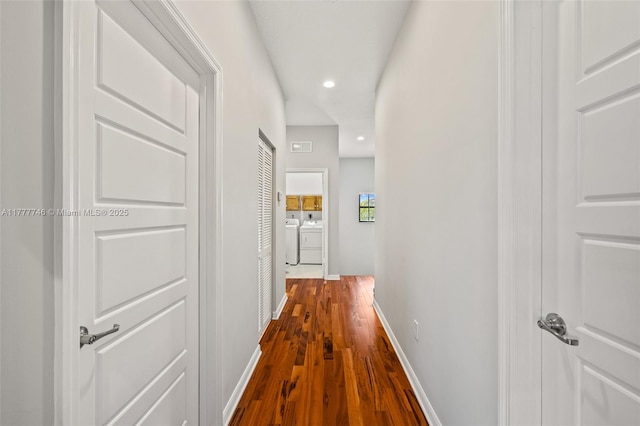 hallway with independent washer and dryer, recessed lighting, baseboards, and dark wood-style floors