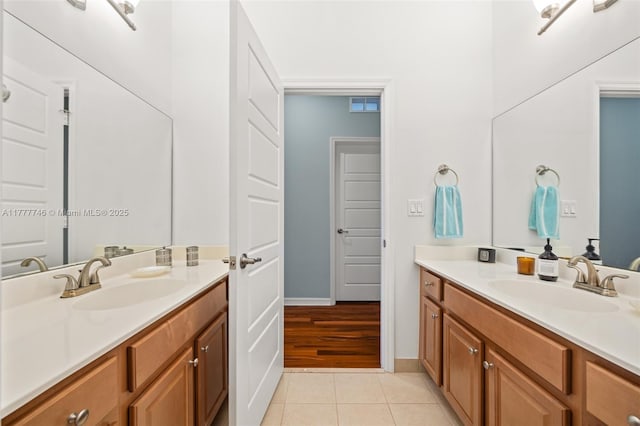 bathroom with a sink, tile patterned floors, and two vanities