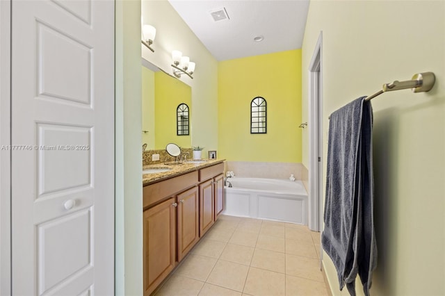 full bathroom with visible vents, a bath, a sink, double vanity, and tile patterned flooring