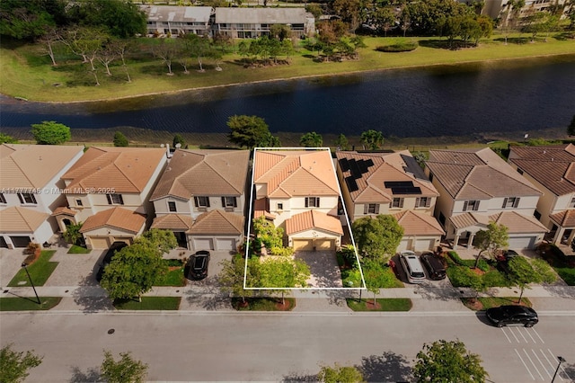 drone / aerial view with a water view and a residential view