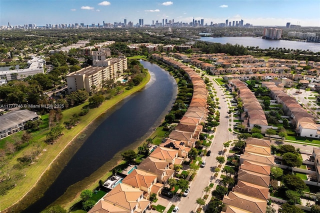 birds eye view of property featuring a view of city and a water view