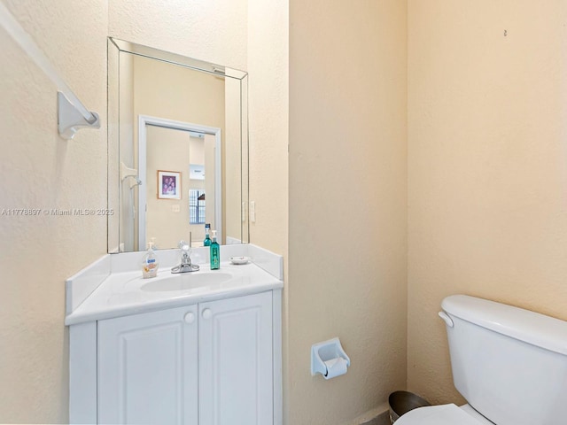 bathroom featuring toilet and vanity