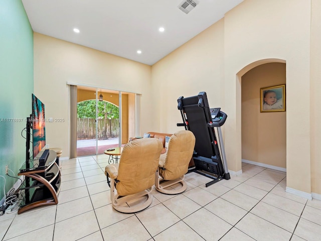 workout area with visible vents, baseboards, arched walkways, recessed lighting, and light tile patterned flooring